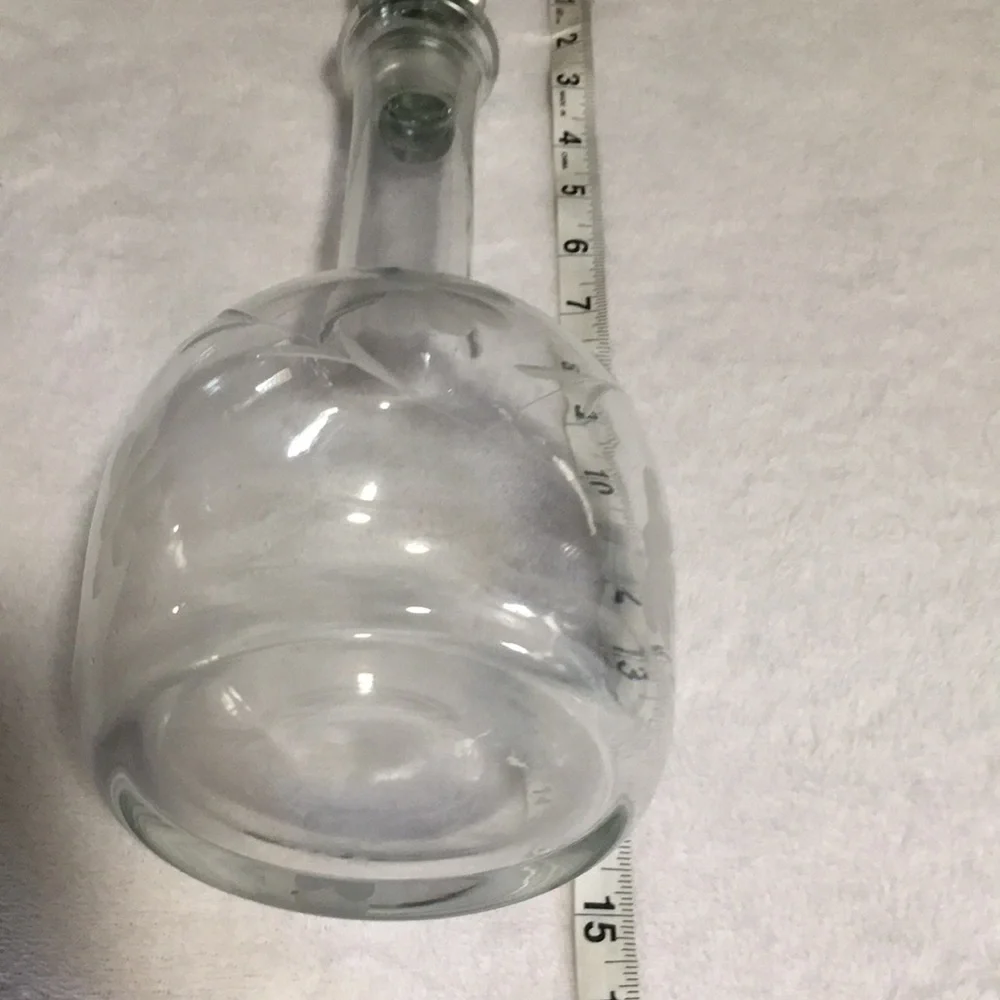 Floral etched glass decanter with stopper.
